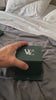 William Corbier RIDGE Dark Azure customer video: hand opening the green gift box on a bed