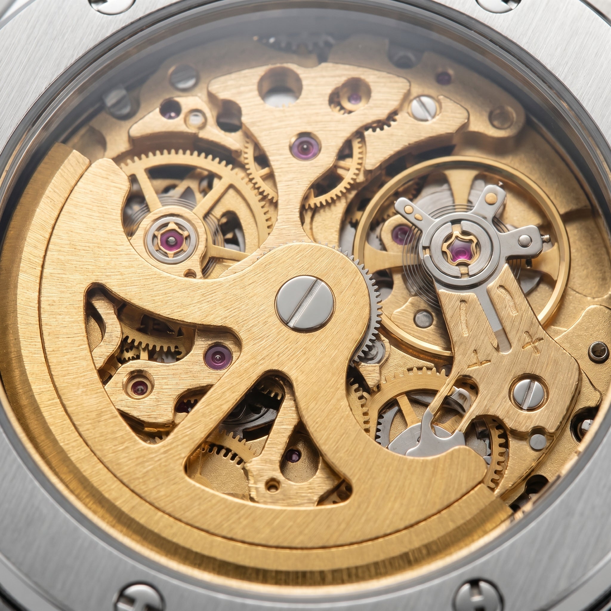 Image of Close-up of a gold automatic watch movement seen through a transparent case back
