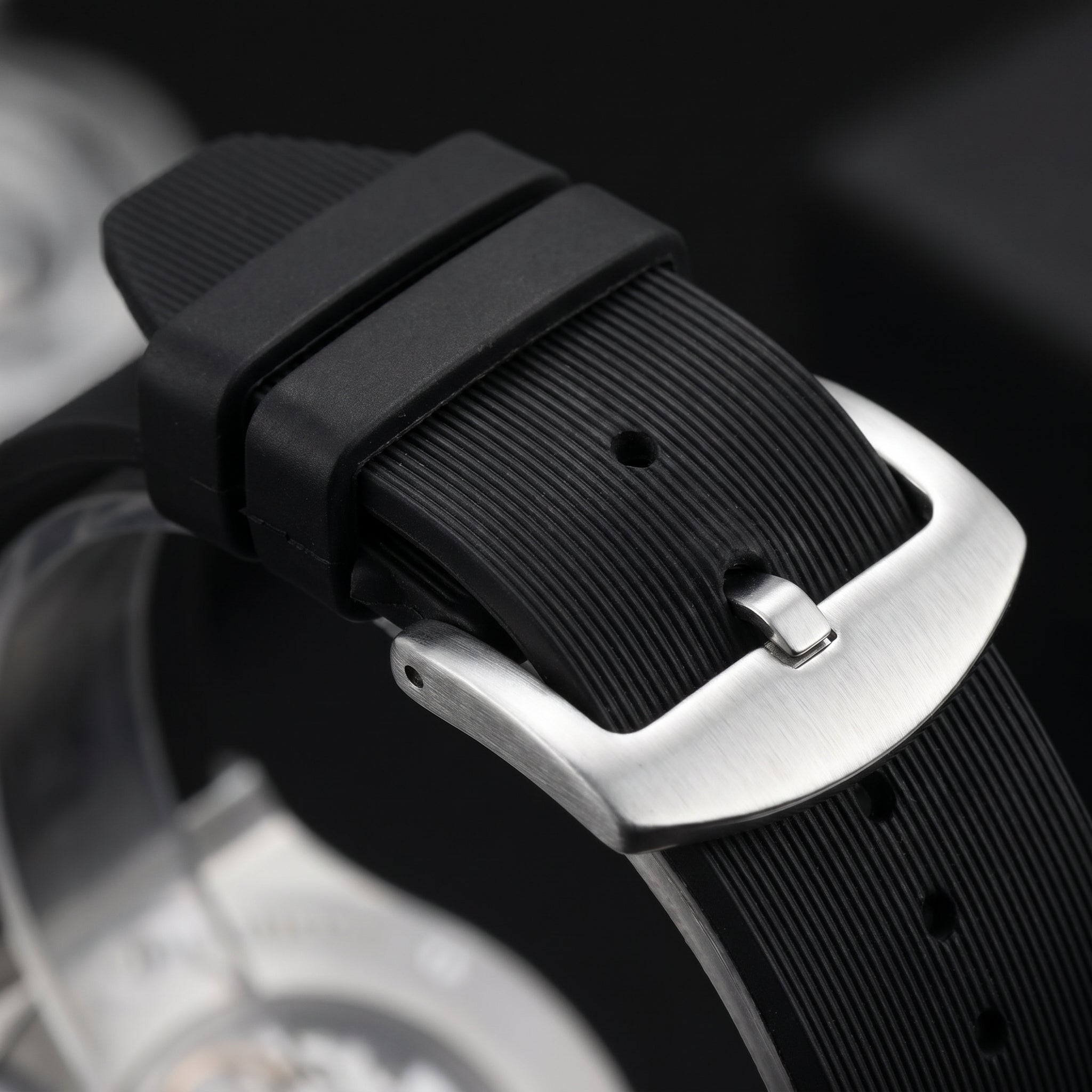Image of Black rubber watch strap with a brushed silver buckle