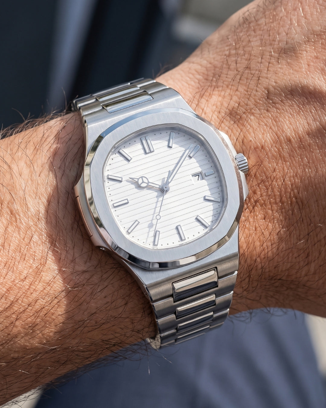 Image of William Corbier CREST Alpine men's white dial steel watch, worn on a wrist with a blue shirt
