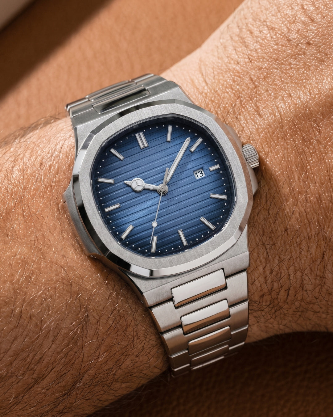 Image of William Corbier CREST Azure Tide men's blue dial steel watch, worn on a tanned wrist