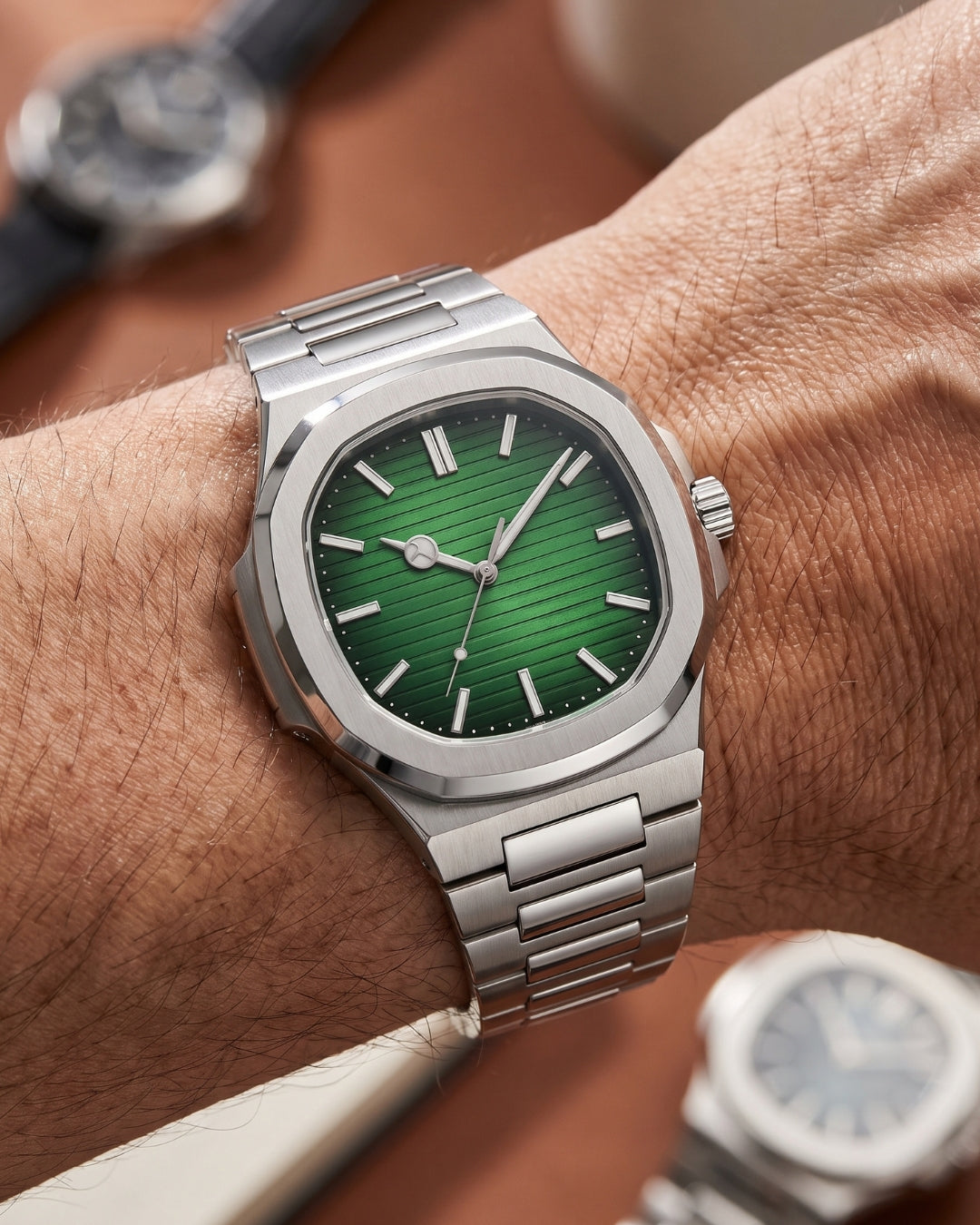 Image of William Corbier CREST Emerald men's green dial steel watch, worn on a wrist beside other watches