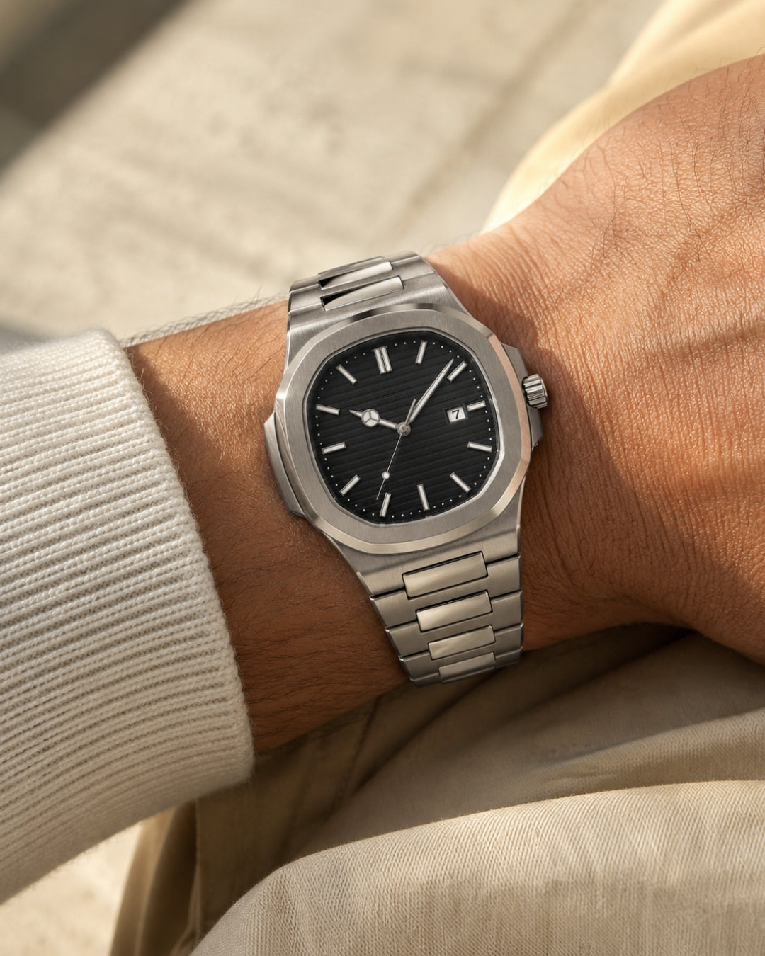 Image of William Corbier CREST Obsidian men's black dial steel watch, worn on a wrist with a light knit sweater