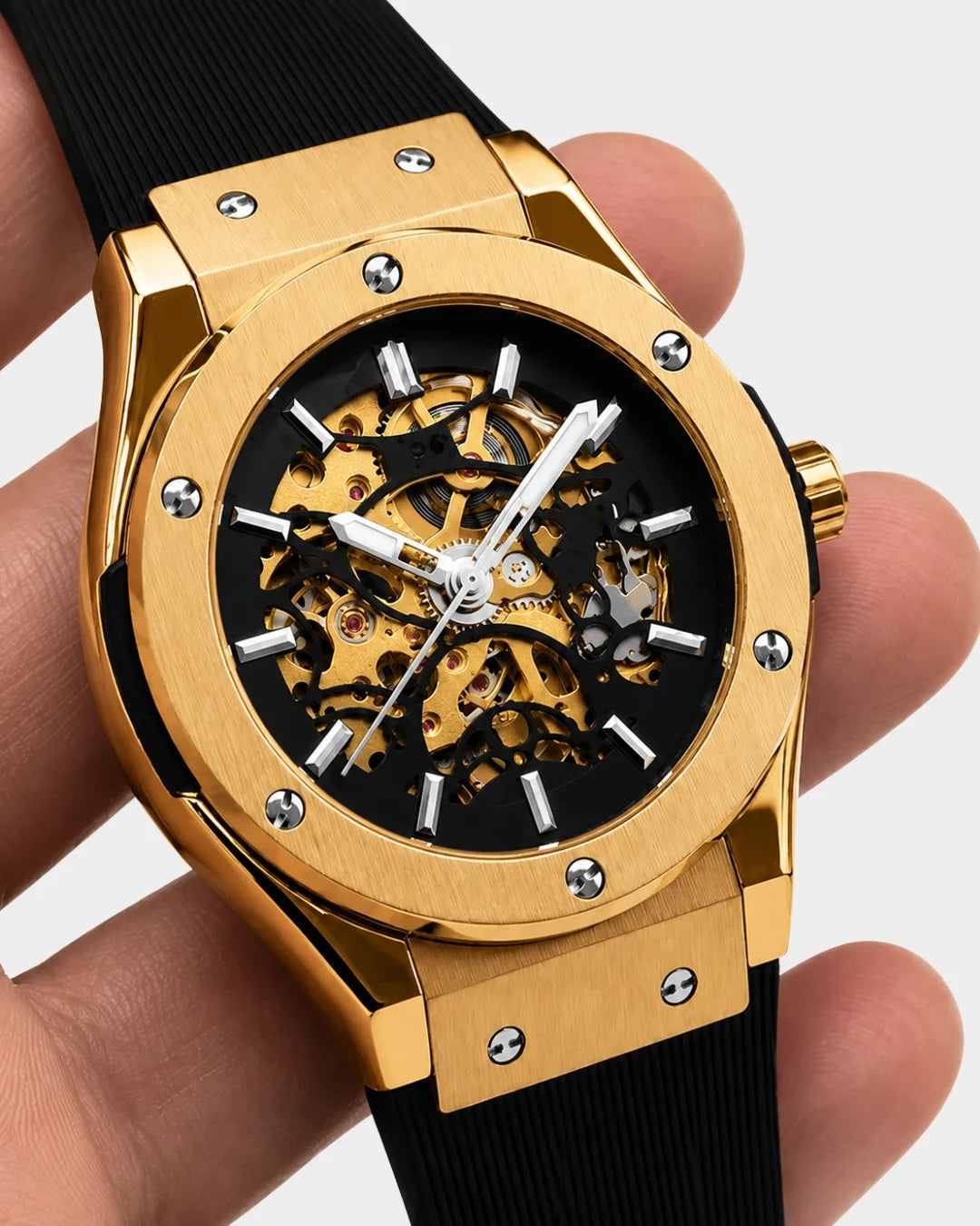 Image of William Corbier MACH Imperial Gold men's automatic skeleton watch, held in a hand