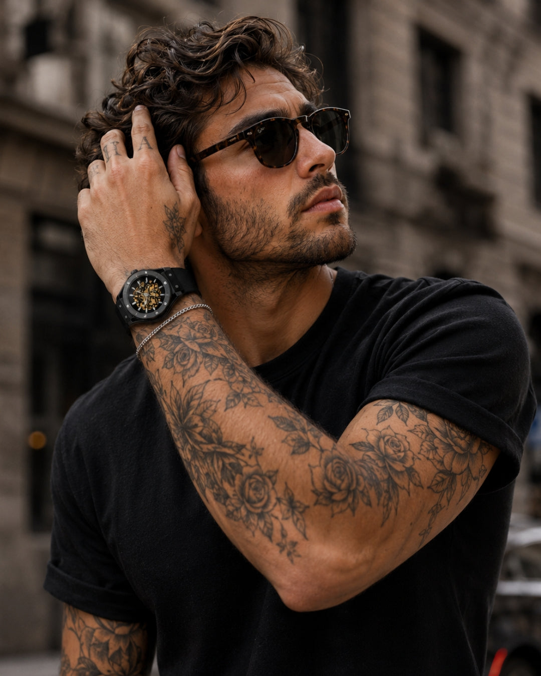 Image of Man with sunglasses and tattoos in a black t-shirt wearing the William Corbier MACH Onyx men's automatic skeleton watch