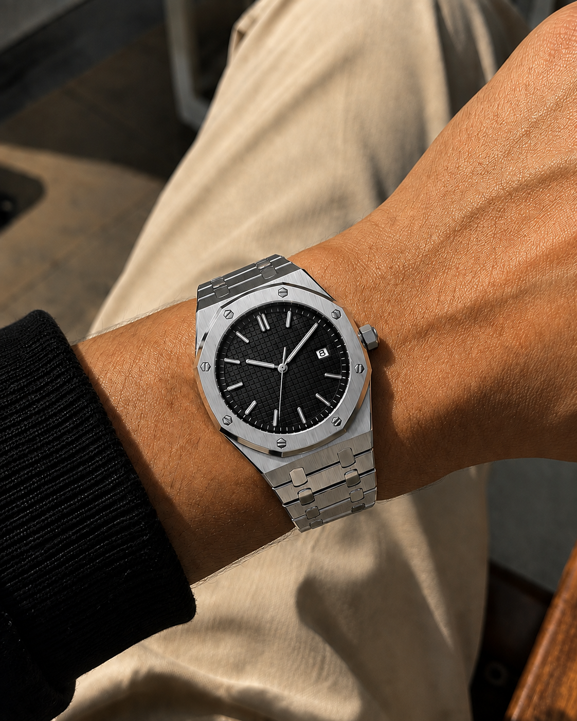 Image of William Corbier RIDGE Obsidian men's black dial steel watch, worn on a wrist with a black sleeve and beige trousers