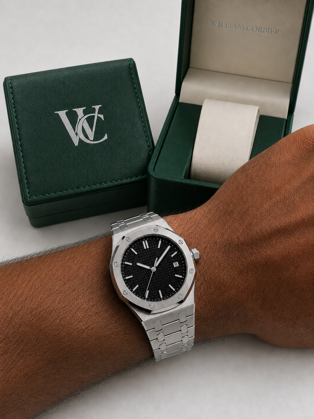 William Corbier RIDGE Obsidian men's black dial steel watch, worn on a wrist beside an open green gift box