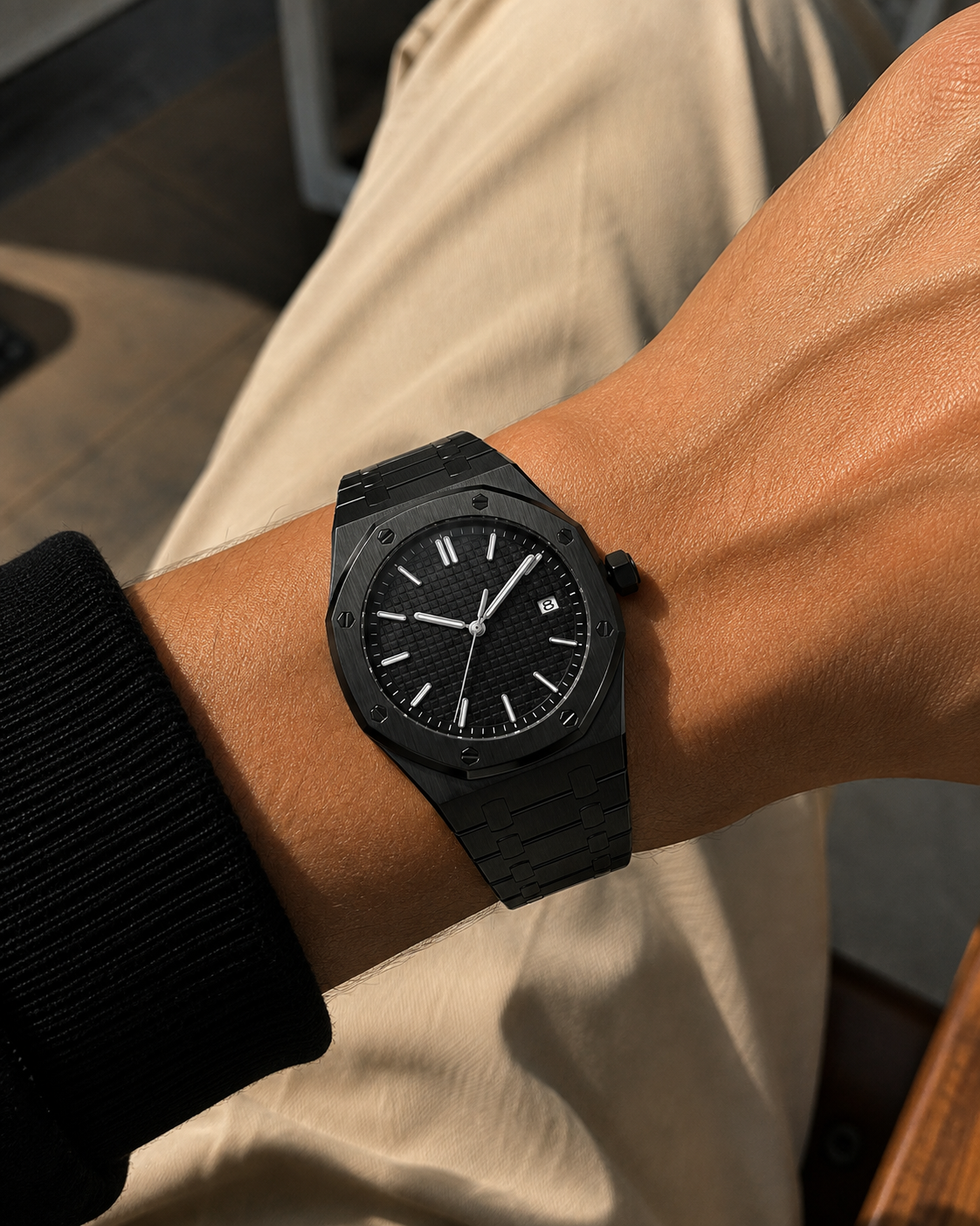 Image of William Corbier RIDGE Onyx men's black dial steel watch, worn on a wrist with a black sleeve and beige trousers