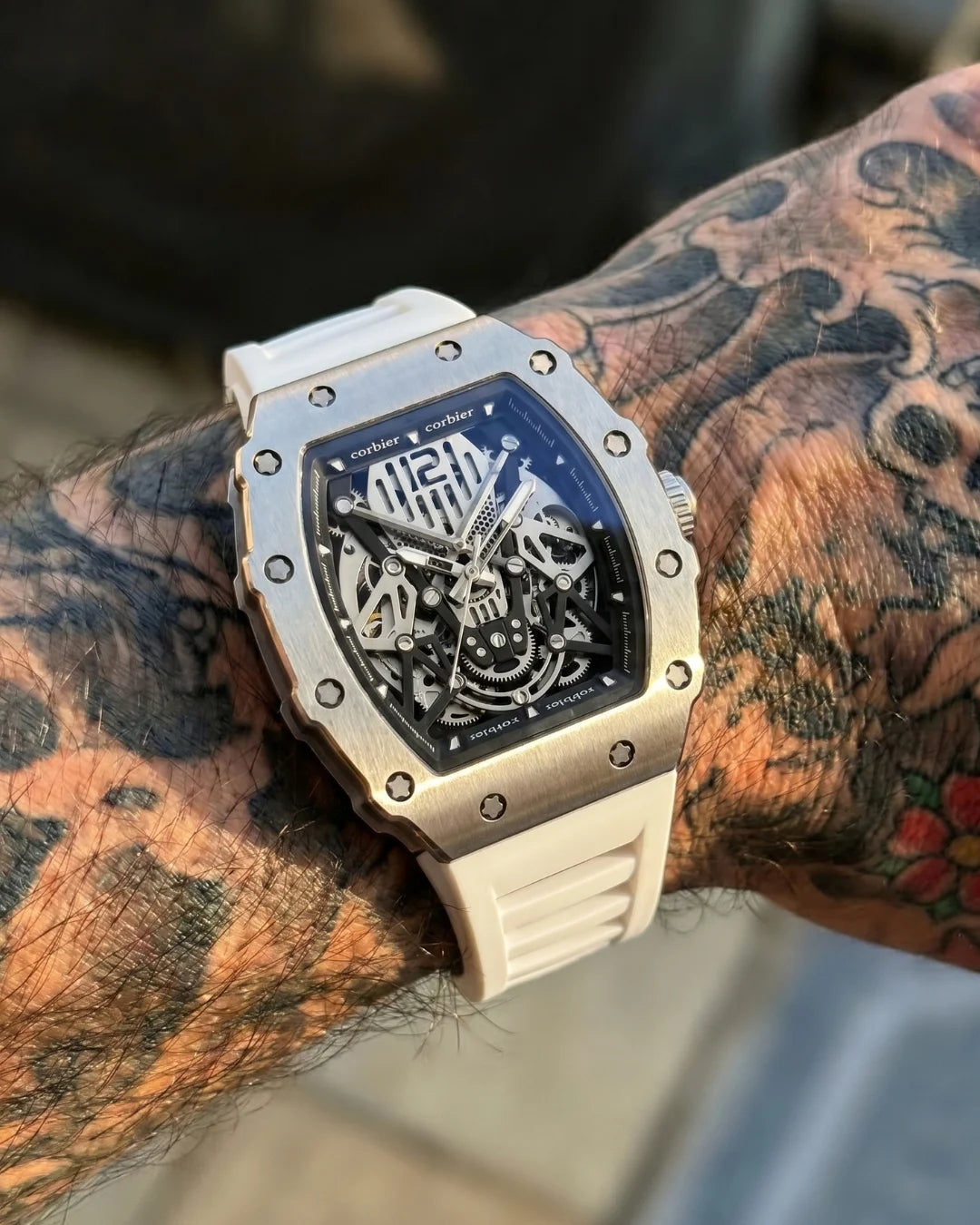 Image of William Corbier SURGE Alpine men's automatic skeleton watch, worn on a tattooed wrist