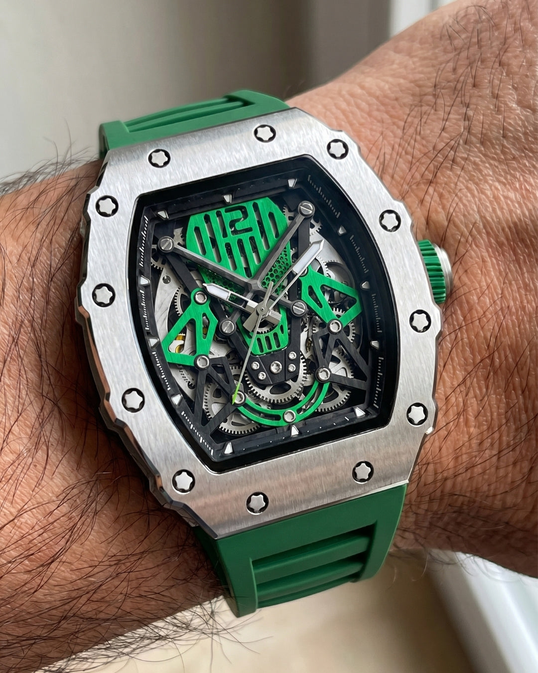 Image of William Corbier SURGE Emerald men's automatic skeleton watch, worn on a wrist close-up on a wrist